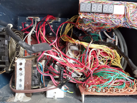 Lots of colorful wires connecting electronic components via perfboard